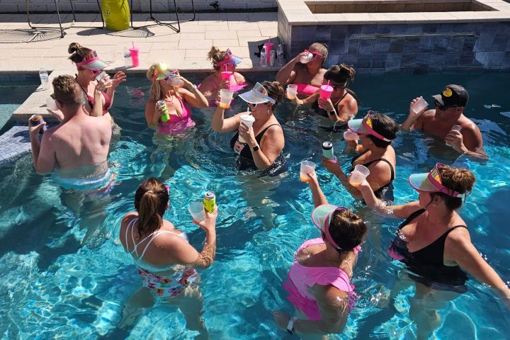 a group of people swimming in a pool of water