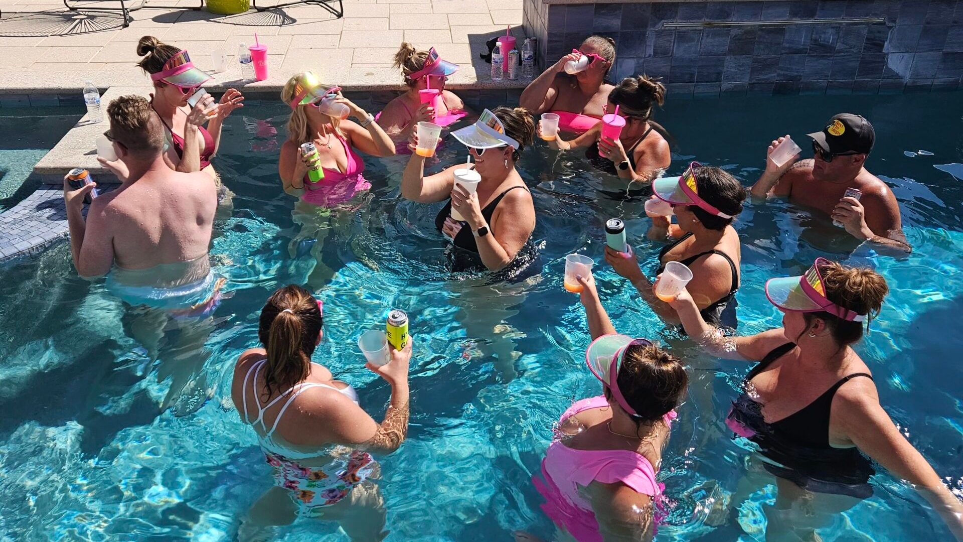 a group of people swimming in a pool of water