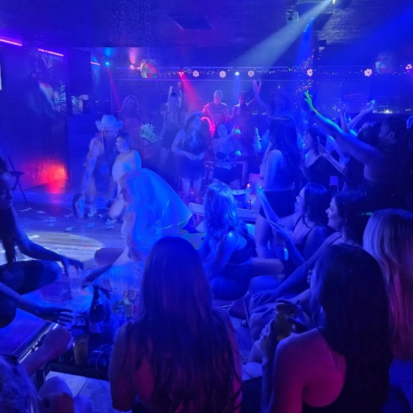 a group of people standing on a stage in front of a crowd