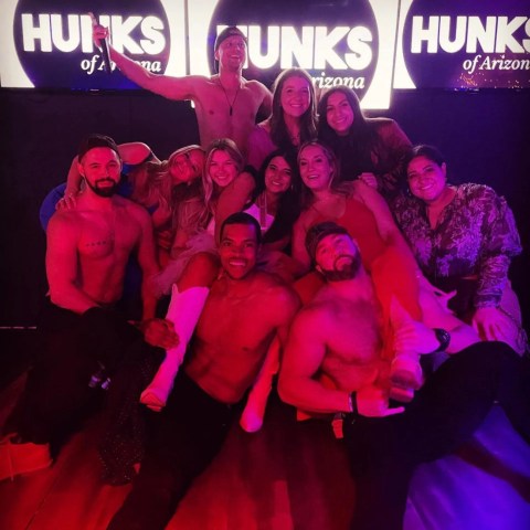 a group of people standing on a stage posing for the camera