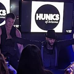 a group of people standing in front of a crowd posing for the camera